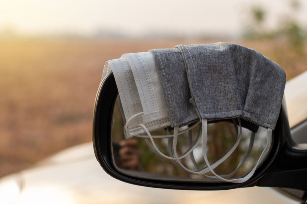 covering car side mirror with face masks