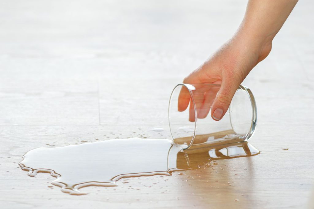 woman cleaning up spilled water