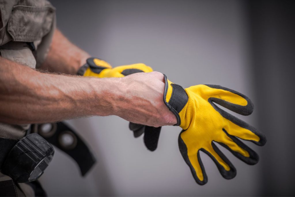 technician puslling safety gloves