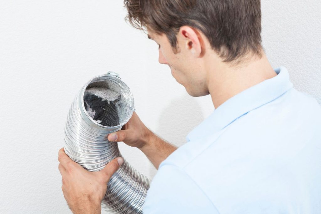 Men looking into a vent tube