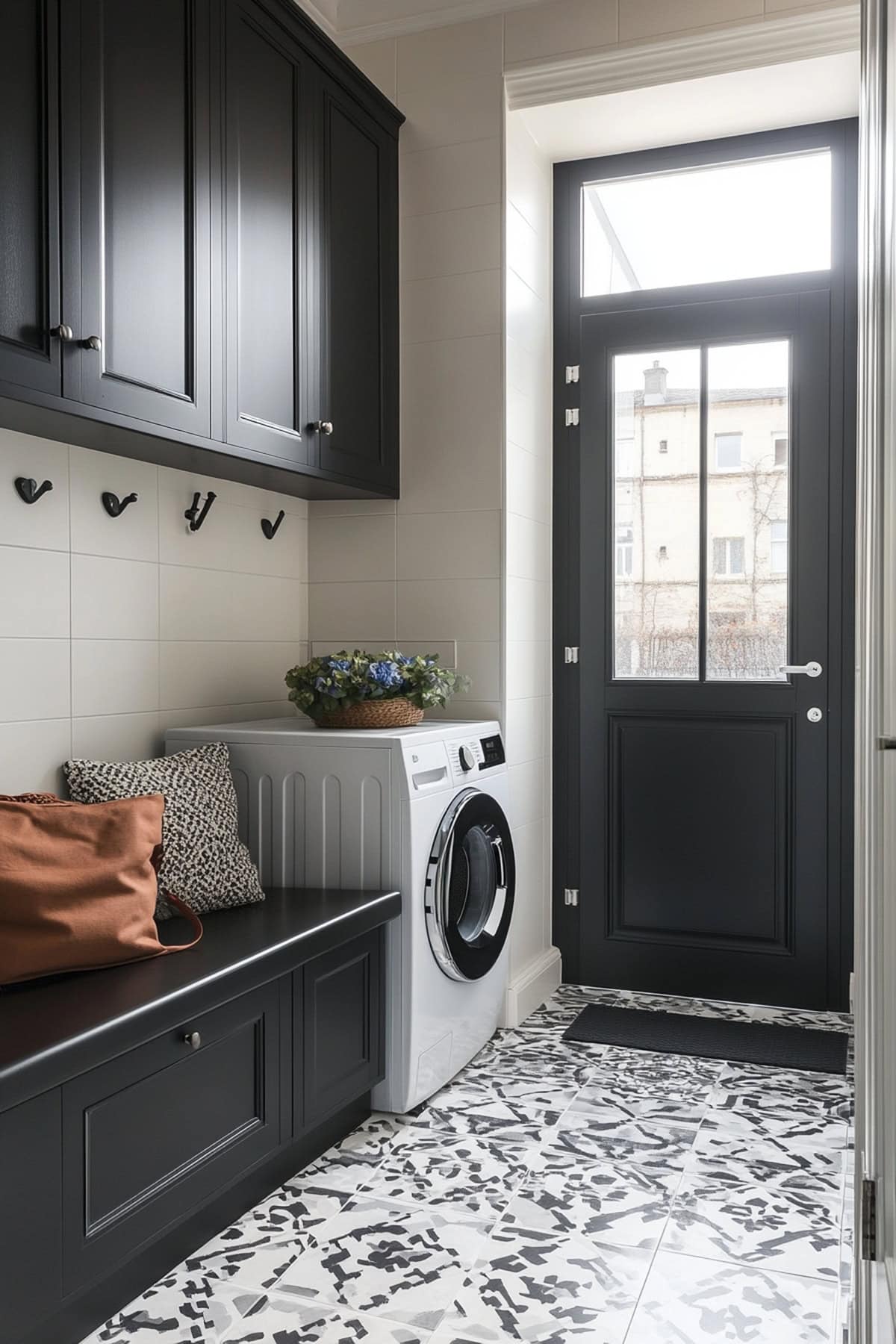 Modern mudroom laundry room featuring geometric tiles and minimalist design.